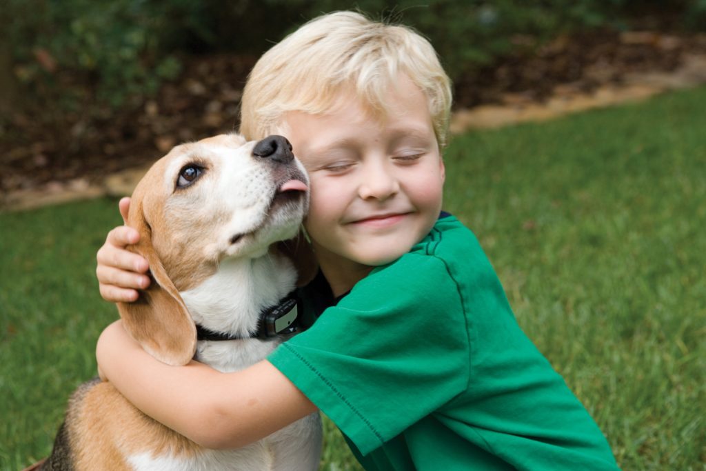 happy-little-boy-hugs-dog-with-love-outdoors
